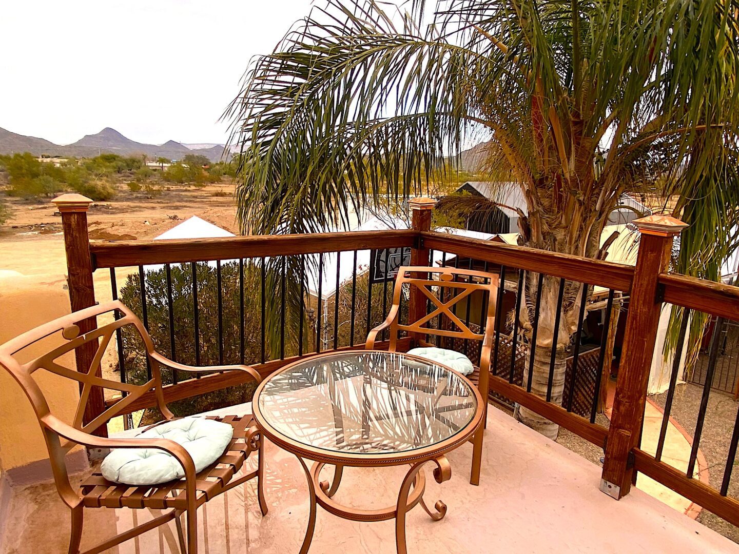 A table and chairs on the porch of a house.