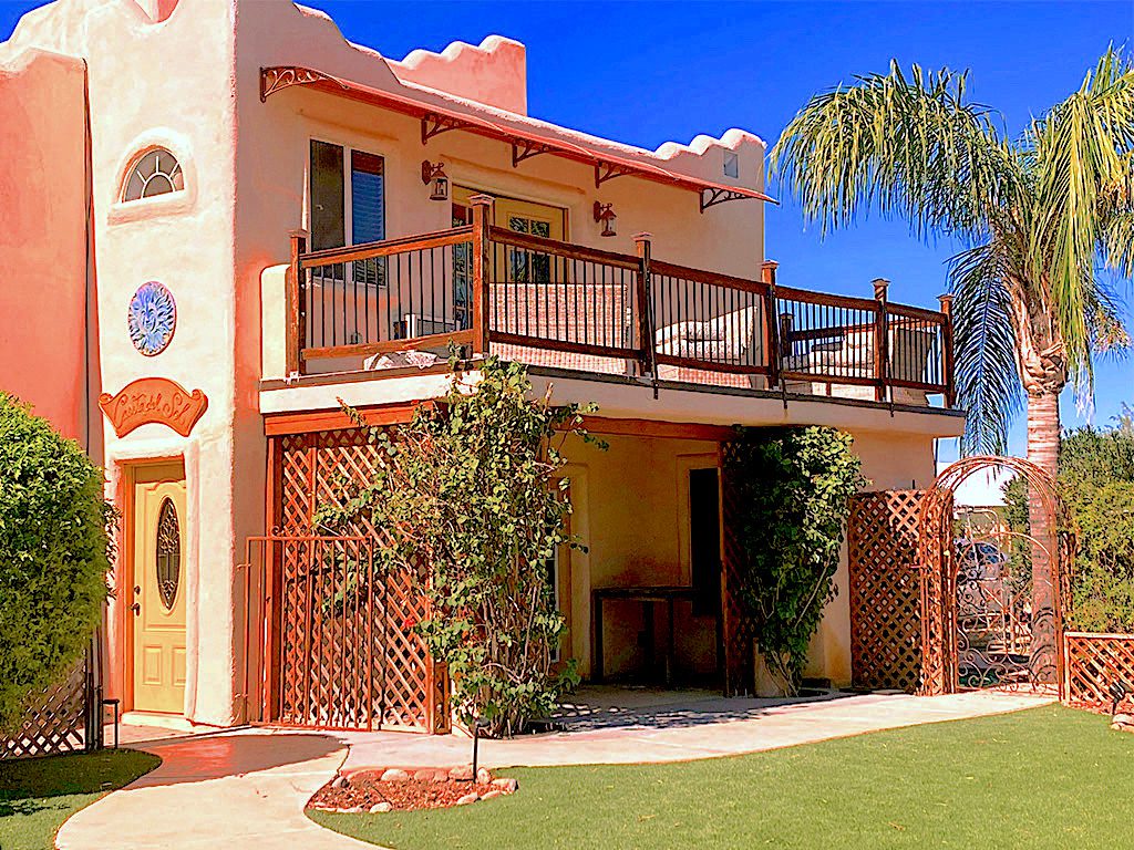 A large house with a balcony and patio.