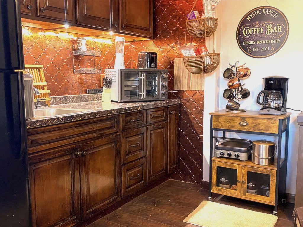 A kitchen with brown cabinets and a coffee maker.