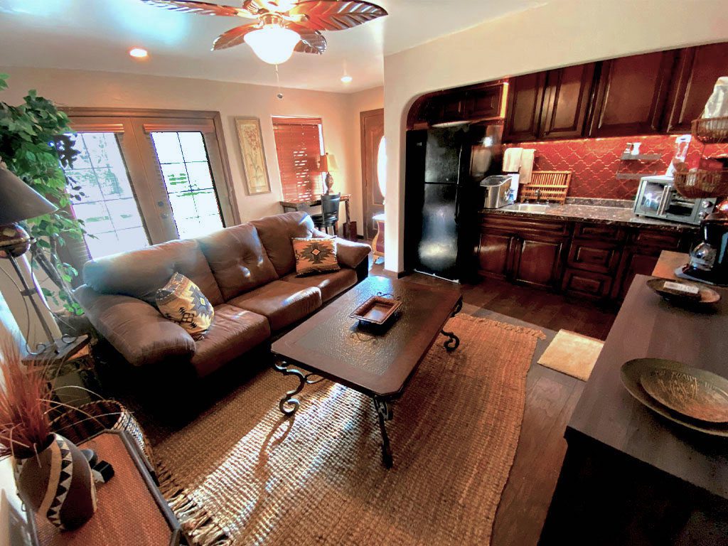 A living room with brown furniture and wooden floors.