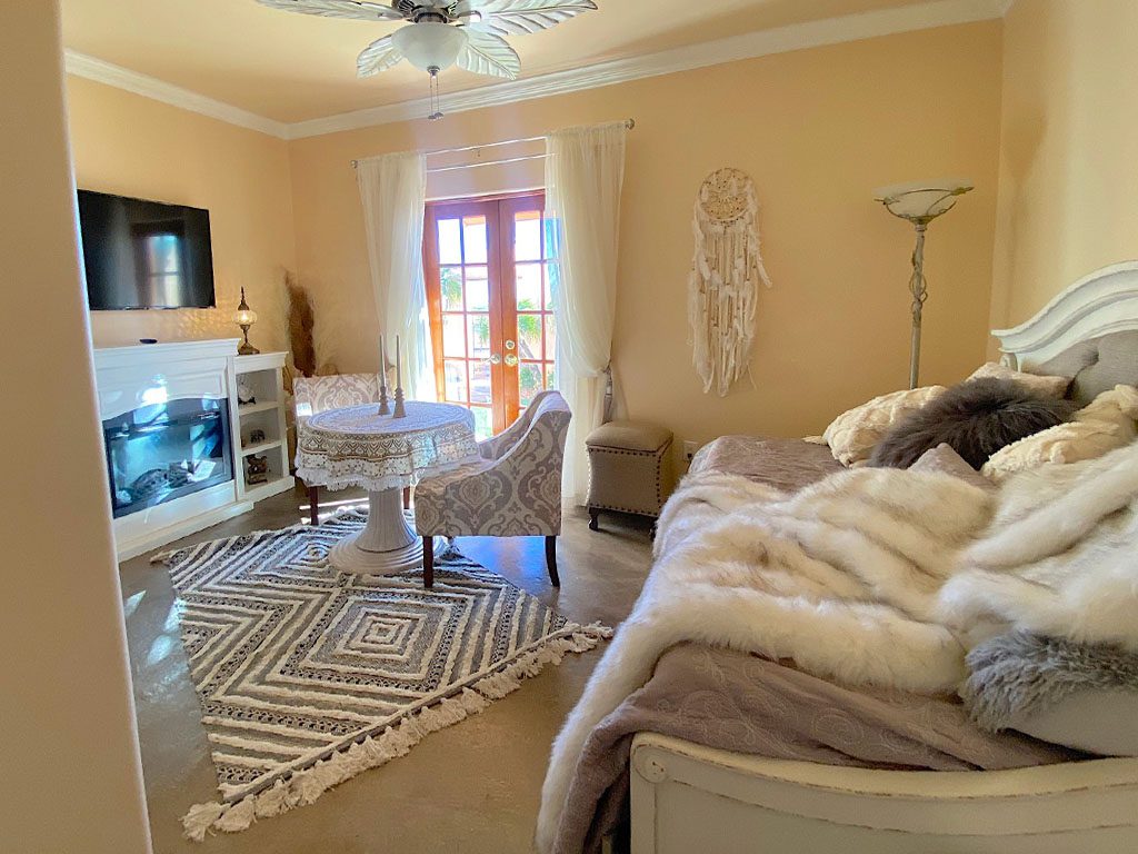 A living room with a couch, chair and television.