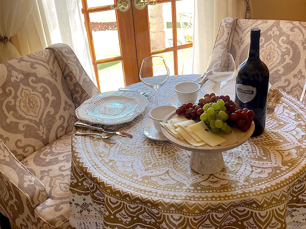 A table with wine and grapes on it